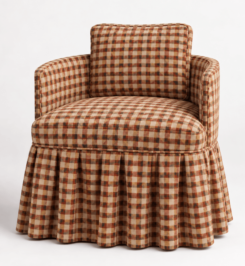 An upholstered barrel armchair featuring a rounded back, integrated rolled arms, and a full pleated skirt that extends to the floor. The chair includes a loose seat cushion and a loose back cushion, all upholstered in a multi-color gingham plaid fabric. The pattern consists of squares in shades of brown, beige, and rust-orange. — 3D model