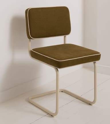 A modern armless chair featuring a continuous tubular metal frame that forms both the sled base and supports the upholstered seat and backrest. The upholstery is a textured moss green fabric, complemented by light beige piping along the edges of the cushions, which matches the color of the metal frame. The design is minimalist and contemporary, providing a clean silhouette suitable for various interior settings. — 3D model