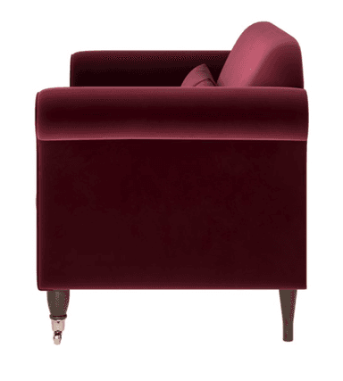 A traditional two-seater loveseat upholstered in deep burgundy velvet. It features classic rolled arms, two loose seat cushions, and two loose back cushions. The frame rests on short, dark wooden legs, with the front legs terminating in brass caster wheels for mobility. The overall design suggests a classic or Victorian-inspired aesthetic. — 3D model
