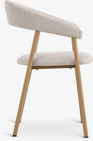 An upholstered dining chair featuring a light natural wood frame and a light beige, textured fabric. The backrest is gently curved, extending to form integrated armrests. The seat and back are fully upholstered, providing a soft seating experience. — 3D model