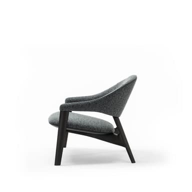A modern armchair with a curved silhouette. The chair features a dark wooden frame and upholstered seat and back in a speckled grey fabric. The armrests are integrated into the frame, flowing from the backrest to the front. — 3D model