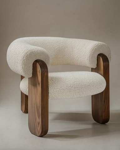 A low-profile lounge chair featuring a thick, rounded seat and back upholstered in white bouclé fabric, supported by a robust dark wood frame with curved, solid legs. — 3D model