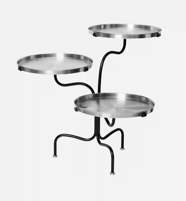 A modern three-tiered accent table featuring circular, brushed metal trays supported by an organically curved black metal frame with brass-capped feet. — 3D model