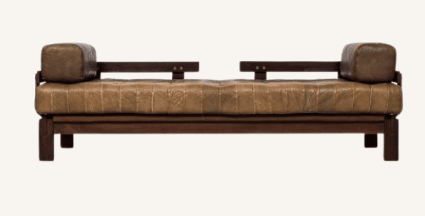 A mid-century style daybed featuring a dark-stained exposed wooden frame and a tufted brown leather cushion, complemented by two cylindrical bolster pillows at each end. — 3D model