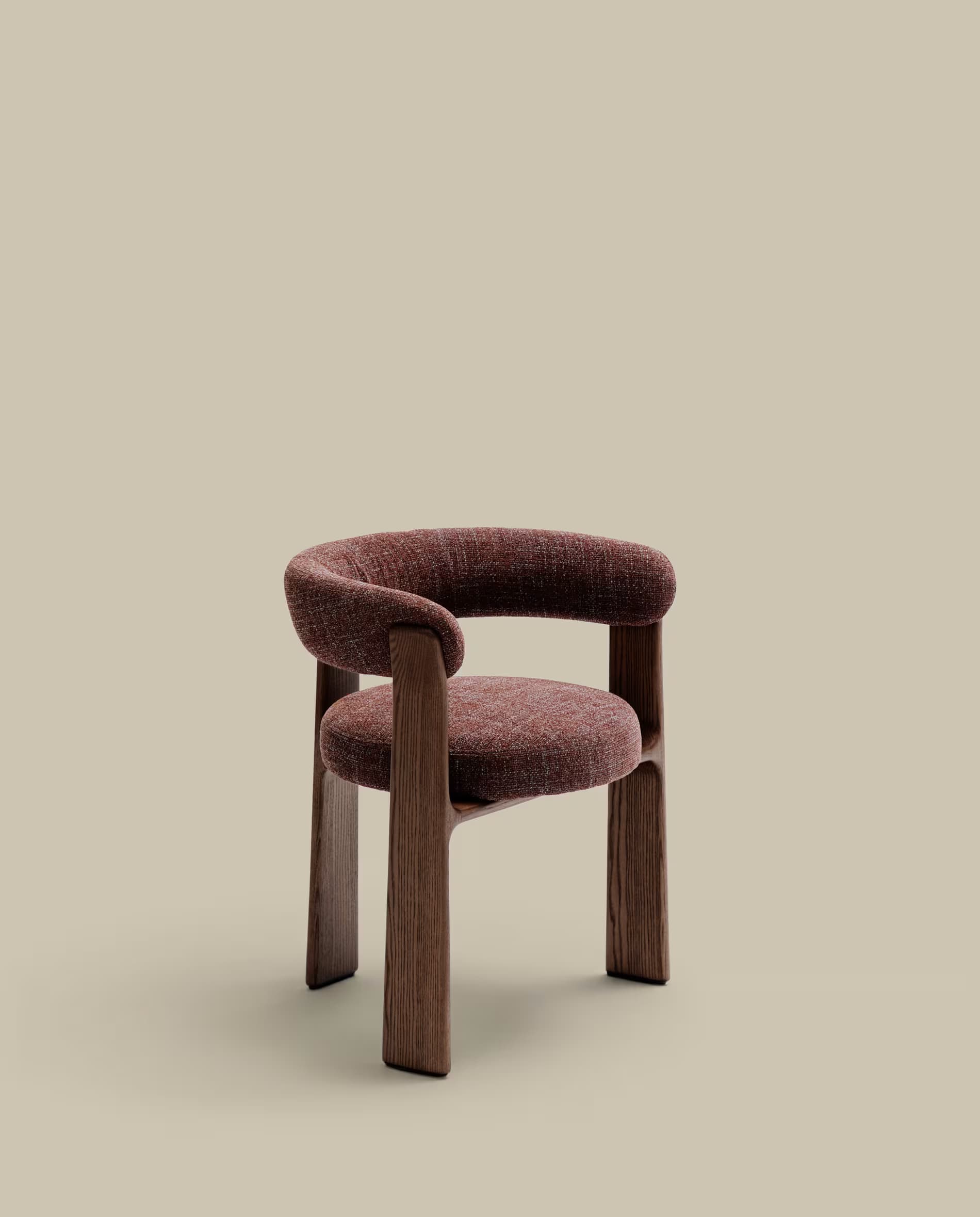 A contemporary dining chair featuring a unique barrel-shaped backrest and seat, fully upholstered in a textured reddish-brown fabric. The backrest curves seamlessly forward to form integrated armrests. The chair is supported by four robust, straight legs made of dark-stained solid wood, showcasing visible wood grain. The design emphasizes clean lines and a modern aesthetic. — 3D model