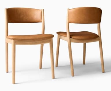 An armless chair featuring a light-toned wooden frame and upholstered seat and backrest in tan leather. The design is minimalist and contemporary, suitable for dining or general seating. — 3D model