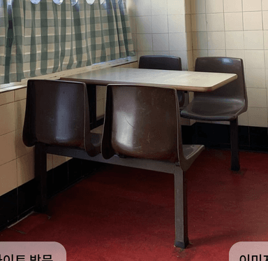A brown and tan integrated cafeteria dining set featuring a rectangular laminate tabletop and four molded plastic seats (two individual chairs and a two-person bench), all attached to a dark brown metal frame. — 3D model