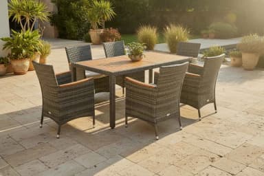 A six-seater outdoor dining set consisting of one rectangular table and six chairs. The table has a slatted wooden top and dark legs. The chairs feature a woven rattan-like exterior, wooden armrests, and light gray seat cushions. A small potted plant is centered on the table. — 3D model