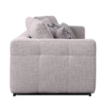 A contemporary three-seater sofa upholstered in a light grey textured fabric, featuring clean lines, track arms with subtle button tufting on the exterior, and generous loose back and seat cushions. It comes with four decorative throw pillows in coordinating grey tones and patterns. — 3D model