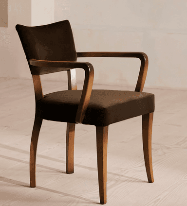 A wooden armchair with upholstered seat and backrest. The chair features curved armrests and four tapered legs. The upholstery is a dark brown fabric, and the wooden frame has a natural wood finish. — 3D model