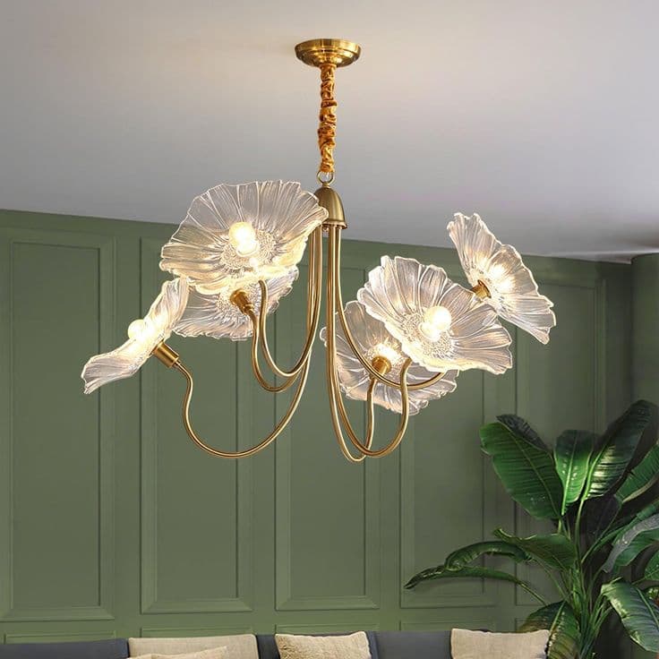 A ceiling-mounted lighting fixture featuring a brass-finished frame and five light sources. Each light is enveloped by a clear, textured glass shade, sculpted to resemble a flower with scalloped petals. The arms of the chandelier are elegantly curved, extending from a central support connected to a ceiling canopy by a short, fabric-wrapped suspension. — 3D model