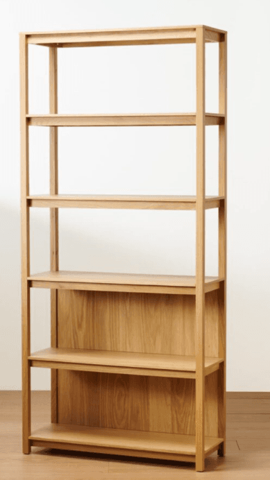 A tall, open-back bookshelf with a light wood finish. It features a minimalist design with five shelves supported by vertical wooden pillars on each side. The shelves are horizontal planes, and the back panel is solid, made of the same wood, covering the lower half of the unit. The overall construction suggests a modern or Scandinavian aesthetic. — 3D model