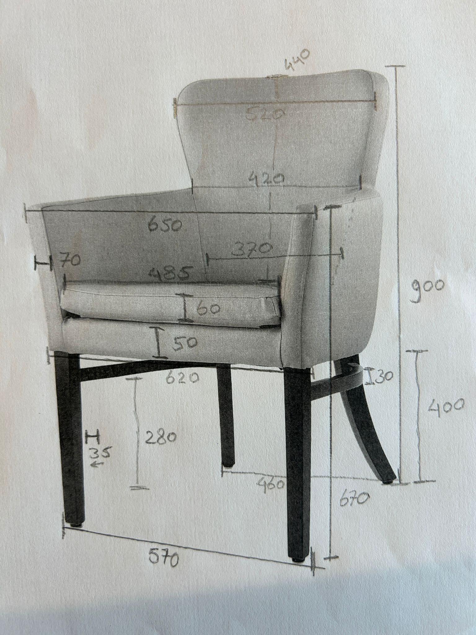 A detailed drawing of an upholstered armchair with various dimensions indicated. The chair features a padded seat, backrest, and armrests, supported by four tapered wooden legs. The upholstery appears to be a light-colored fabric, and the legs are dark. — 3D model