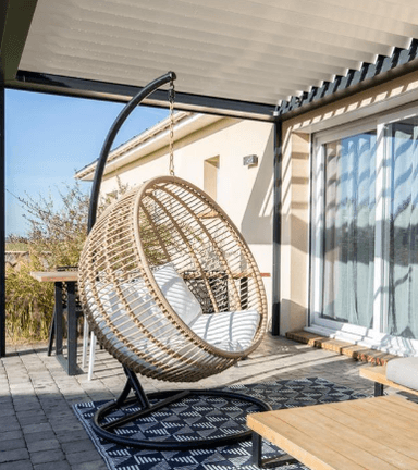 A single-person hanging egg chair featuring a woven rattan basket suspended from a black metal stand. The chair includes soft white cushions for comfort. — 3D model