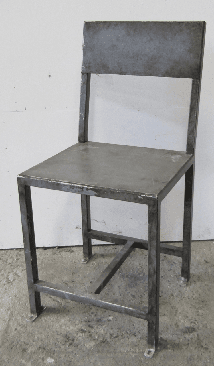 A utilitarian industrial side chair constructed entirely from raw, unfinished steel. It features a simple design with a square seat, a rectangular backrest, and a frame made from square-section metal tubing. The chair shows signs of use and an aged patina typical of industrial metalwork. — 3D model