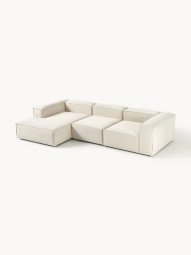 A modular sofa with clean lines and a low profile. It appears to be upholstered in a textured fabric and consists of multiple sections, suggesting flexibility in configuration. The sofa has a contemporary design with a boxy silhouette and visible stitching that delineates the segments. — 3D model