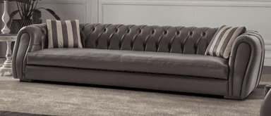 A contemporary chaise lounge featuring deep button tufting on its curved ends and pleated detailing along its side, upholstered in a light taupe leather. — 3D model