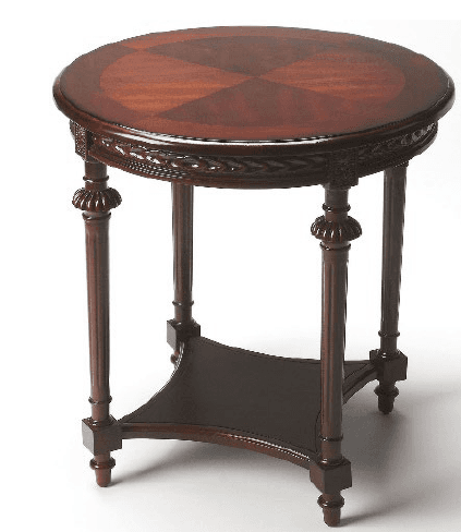 A round accent table made of dark-stained wood, featuring a decorative inlaid tabletop with a checkerboard pattern, a carved apron, four turned and fluted legs, and a triangular lower shelf connecting the legs. — 3D model