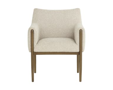 A contemporary armchair featuring a structured yet inviting design. It has a light-toned, textured boucle-like upholstery covering the seat, back, and armrests. The chair is supported by a slender metal frame with a warm, aged brass or bronze finish, which extends upwards to elegantly wrap around the outside of the upholstered armrests. The legs are straight and tapered, providing a clean, modern aesthetic. — 3D model