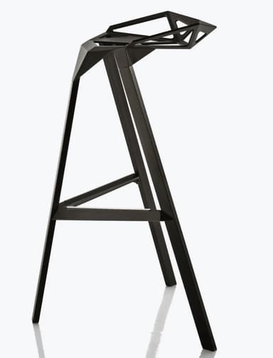 A modern bar stool with a geometric, faceted seat and a matte black finish. It features three angled legs connected by a lower support structure. The seat has an open, angular design with triangular and hexagonal cutouts. — 3D model