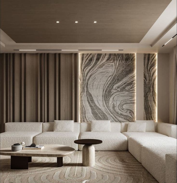 A modern modular sectional sofa upholstered in a light-colored, textured boucle fabric, featuring multiple interchangeable units and an accompanying ottoman. The design is low-profile with clean lines and includes several small throw pillows for back support. — 3D model