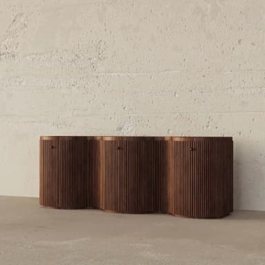 A long, low wooden storage unit featuring a distinctive wavy front composed of vertical reeded panels. The dark wood finish enhances its modern and sculptural aesthetic. — 3D model