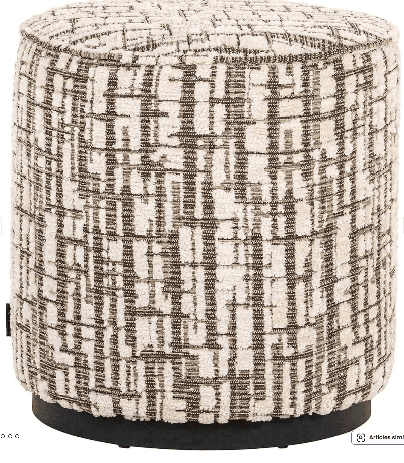 A cylindrical ottoman upholstered in a textured fabric with a geometric pattern. The fabric has a cream or off-white base with a repeating abstract brown grid design. The base of the ottoman appears to be made of a dark, solid material, likely wood or metal, and is circular. — 3D model