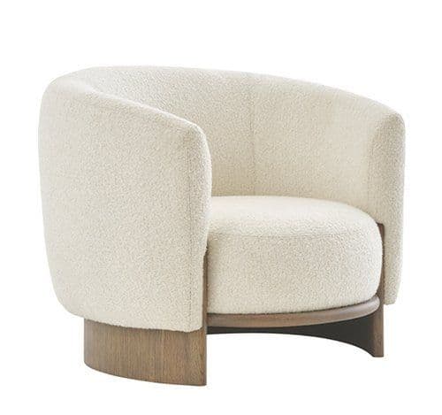 This is a contemporary armchair featuring a rounded, barrel-like silhouette. It is upholstered in a textured, off-white bouclé fabric, providing a soft and inviting appearance. The chair rests on a distinct solid wood base, which curves gracefully along the bottom edge, adding an organic and modern touch to the design. The integrated back and armrests form a continuous, enveloping shape. — 3D model