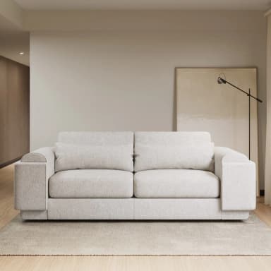 A contemporary sofa with a rounded, sculptural form. It features a textured boucle upholstery and includes multiple throw pillows. The base has a low profile, giving it a modern aesthetic. — 3D model