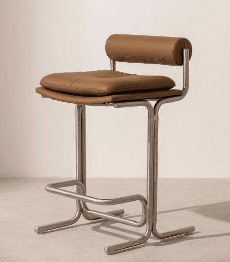 A modern bar stool with a brushed metal frame and a padded seat and backrest upholstered in brown leather. The frame features a U-shaped base with horizontal footrests and curved supports leading to the seat and a cylindrical backrest. — 3D model