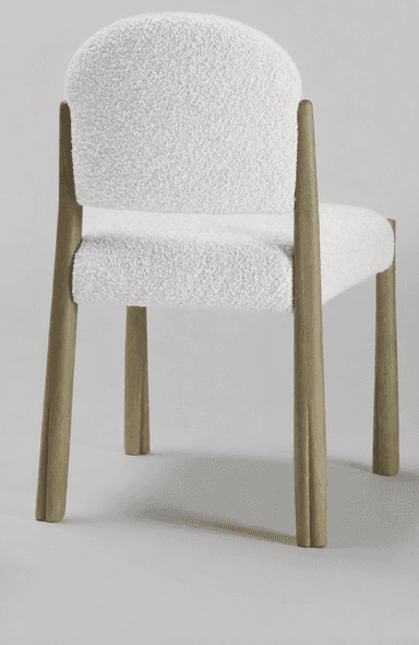 A contemporary dining chair featuring a rounded, padded backrest and seat, both upholstered in off-white boucle fabric. It is supported by four solid, tapered wooden legs with a light, natural finish, exhibiting subtle fluting at the base. — 3D model