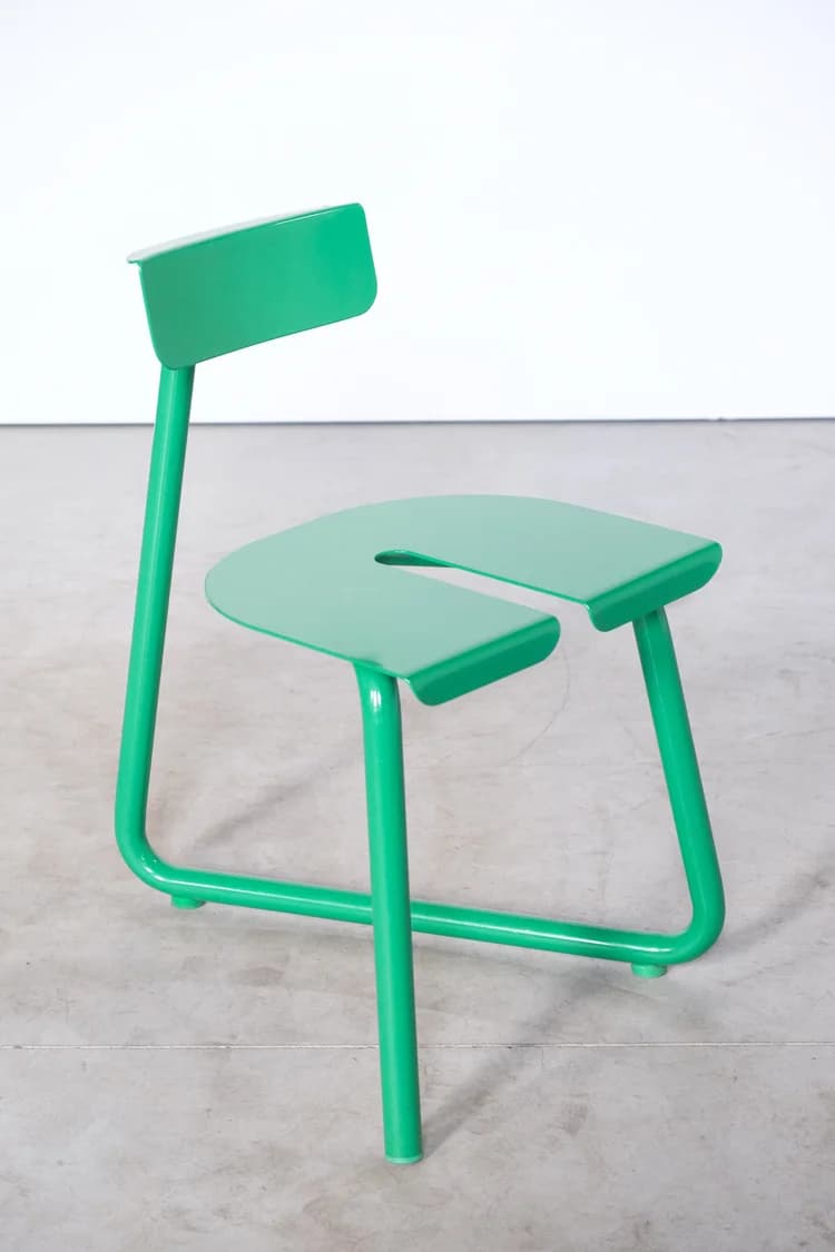 A bright green contemporary chair featuring a minimalist design. It has a distinctive U-shaped seat and a small rectangular backrest, both constructed from continuous tubular metal. The entire frame is finished in a uniform, glossy green. — 3D model