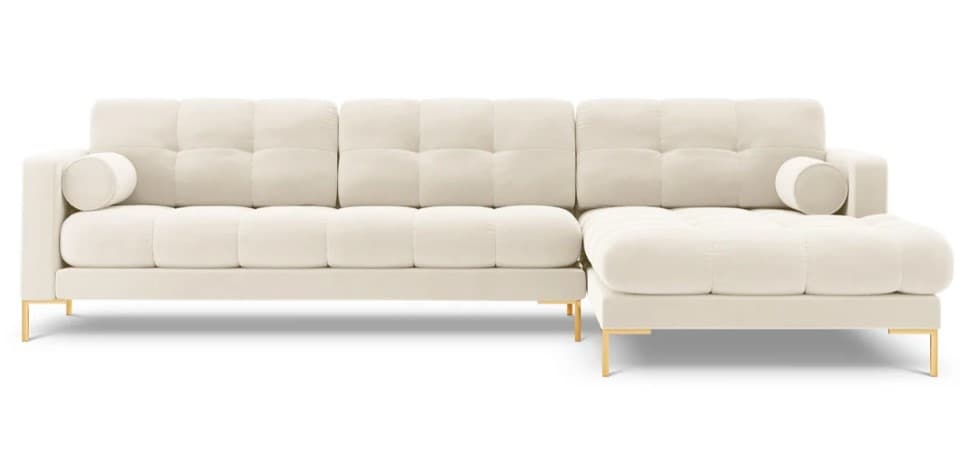 An L-shaped modern sectional sofa upholstered in a cream or off-white fabric, featuring deep button tufting on the seat and back cushions. It includes a detached chaise lounge section and is supported by slender, gold-finished metal legs. Two cylindrical bolster pillows are placed at each end of the main sofa component. — 3D model