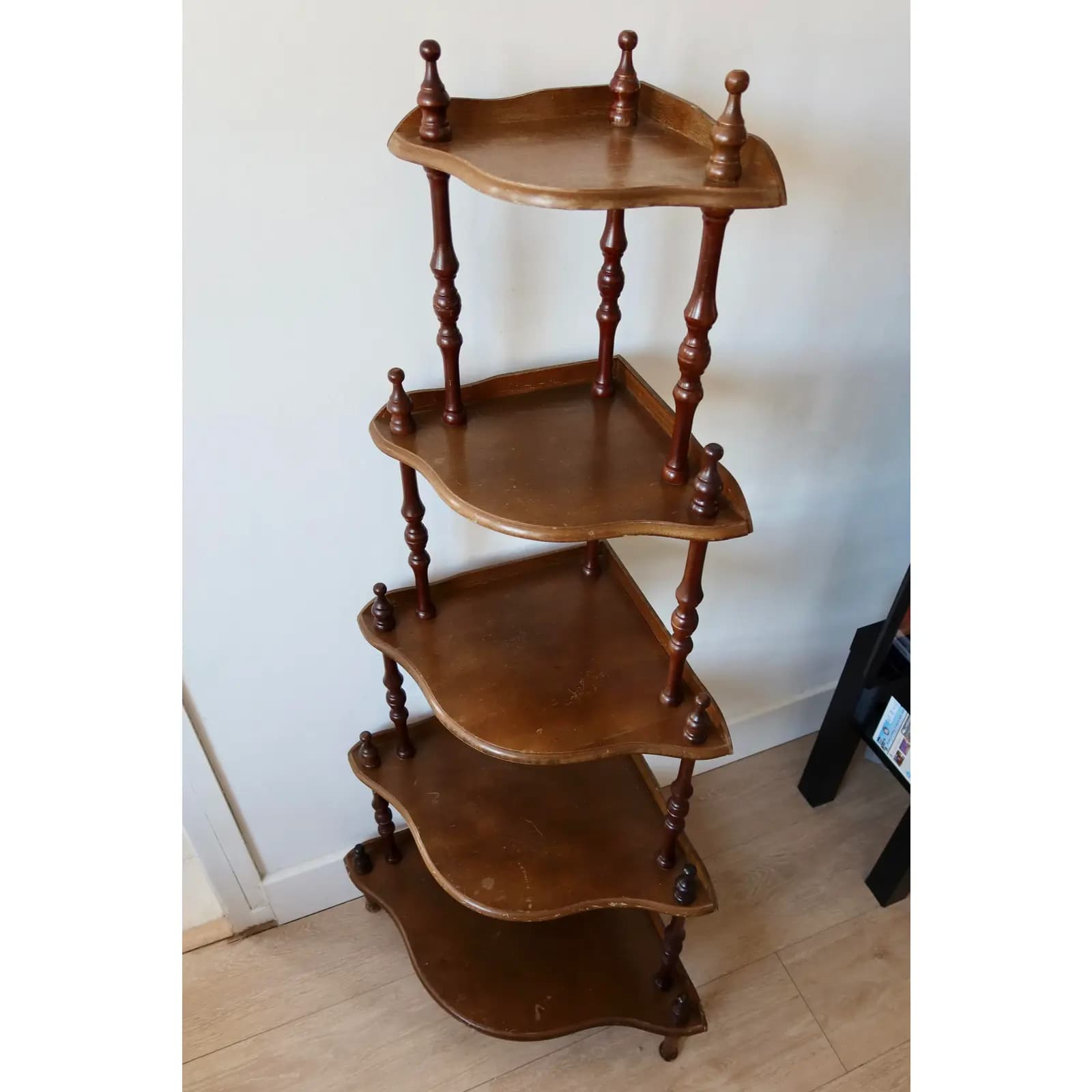 A wooden five-tier corner display shelf with turned spindle supports and decorative finials, designed to fit into a room's corner. — 3D model