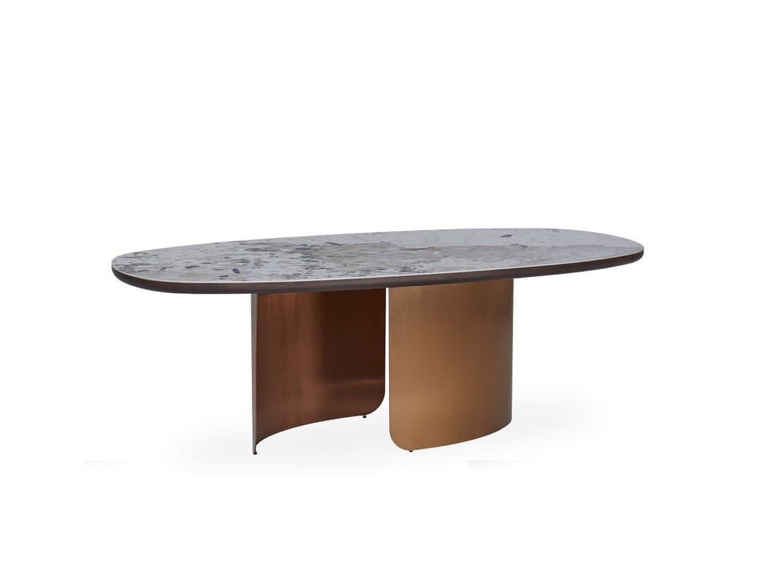 An oval coffee table with a stone-patterned top and a metallic base. The base consists of two curved, vertical elements that support the tabletop, creating an open and modern aesthetic. The top surface has a marbled or veined pattern in gray and white tones, with a dark edge. The base appears to be made of a polished metal with a bronze or copper finish, exhibiting a warm, reflective sheen. — 3D model