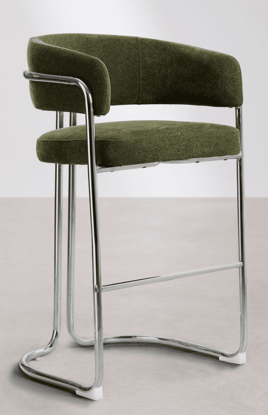 A contemporary bar stool featuring olive green upholstered seating, a curved backrest, and integrated armrests supported by a polished tubular chrome frame with a sled base and footrest. — 3D model