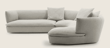 A sectional sofa with a curved, modular design, upholstered in a light-colored, textured fabric. The sofa features multiple seating sections and detached cushions for comfort. It is arranged in a semi-circular configuration, suggesting it is designed for a corner or open-plan space. — 3D model