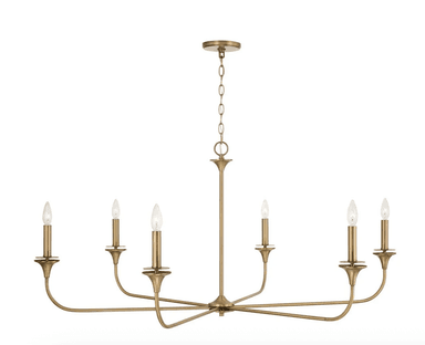 This is a modern six-light chandelier featuring a brushed brass finish. It has a central vertical stem with a chain suspension leading to a round ceiling canopy. Six slender, curved arms extend horizontally from the central body, each terminating in an upright, candelabra-style bulb holder with a small, cupped bobeche. The exposed bulbs are in a flame-tip or torpedo shape, typical of candelabra lights. — 3D model