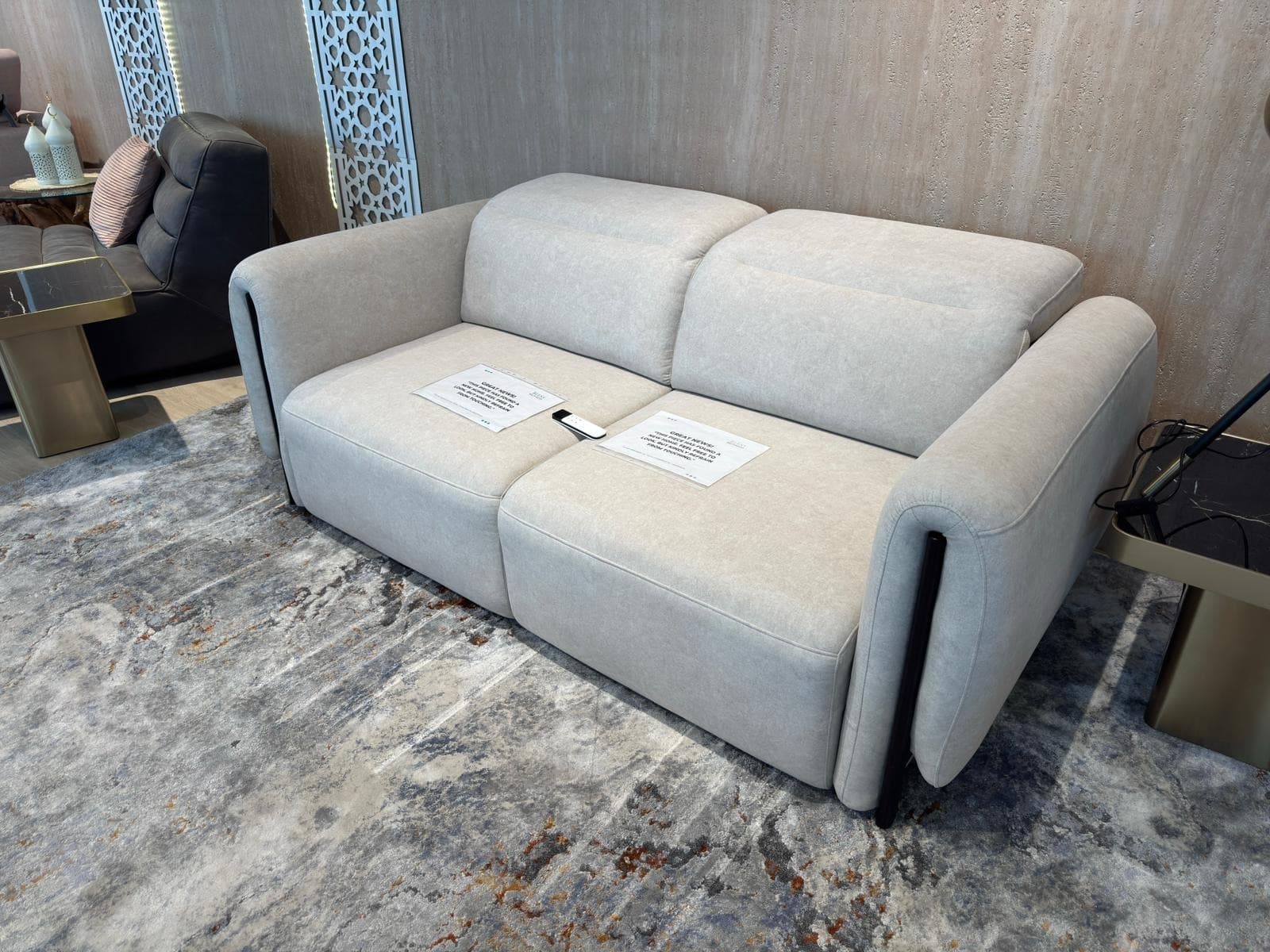 A modern two-seater sofa with a light-colored upholstered body and contrasting dark side panels. The sofa features a clean, contemporary design with rounded armrests and distinct seat cushions. It is presented against a plain white background, likely for product display. — 3D model