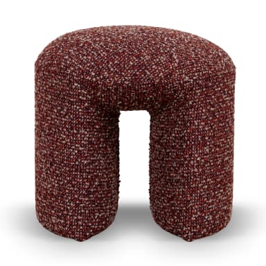 A U-shaped stool upholstered in a textured, multi-colored fabric. The stool has a rounded top and two cylindrical legs connected by a central arch, forming an open space in the middle. The upholstery features a mix of deep red, white, and light brown fibers, creating a speckled appearance. — 3D model