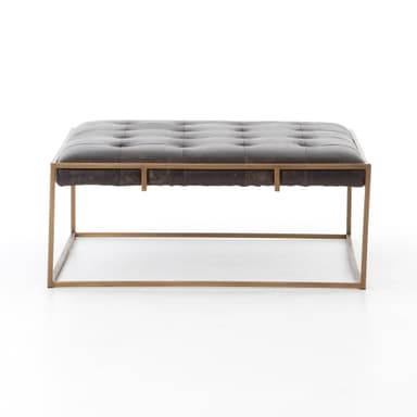 A square tufted ottoman with a dark brown leather top and a thin metal frame. The frame has a brushed brass or gold finish and forms a minimalist base with intersecting support beams. The leather upholstery features deep button tufting. — 3D model