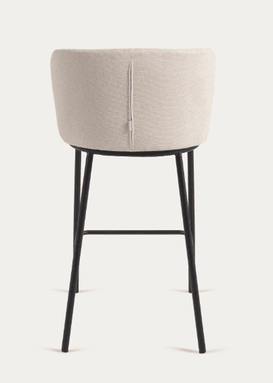 A modern upholstered bar stool with a curved backrest and a black metal frame. The seat and back are covered in a textured, light-colored fabric. The frame consists of four slender legs connected by horizontal supports for stability. — 3D model