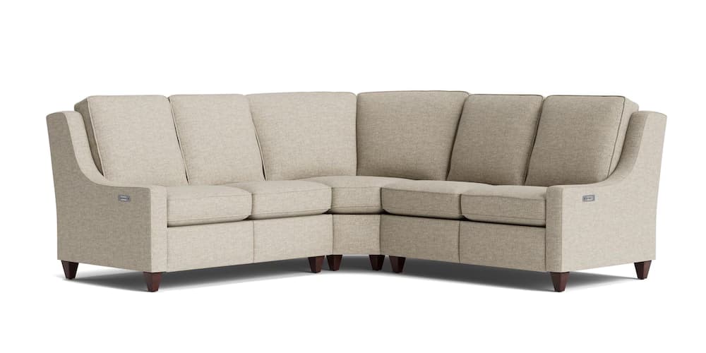 A sectional sofa with a contemporary design, upholstered in a light beige textured fabric. It features a configuration that forms an 'L' shape, composed of multiple seating modules. The sofa has high, slightly flared arms and distinct back cushions. Dark wooden legs provide support. A metallic rectangular emblem is visible on the outer side of one armrest, suggesting potential integrated features like power reclining or USB ports. — 3D model