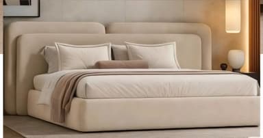 A modern platform bed featuring a fully upholstered frame and headboard in a neutral beige fabric. The headboard is composed of two distinct, rounded, and slightly angled panels that create a soft, contemporary aesthetic. The platform base is integrated with the headboard, providing a clean, minimalist profile. The bed is dressed with matching neutral bedding, including pillows and a decorative throw. — 3D model