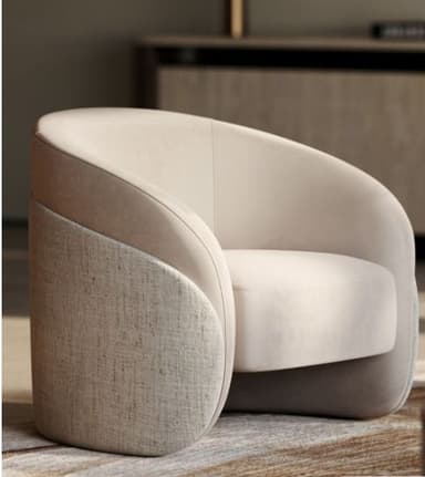 A contemporary upholstered barrel armchair featuring a continuous curved back and armrests, with a two-tone material application. The upper and inner surfaces are upholstered in a smooth, light beige material, while the lower exterior of the chair is covered in a contrasting textured cream-colored fabric. — 3D model