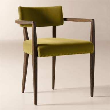 A wooden armchair with upholstered seat and back. The frame is constructed from dark wood with visible grain. The seat and back are upholstered in a textured, mustard-yellow velvet fabric. The upholstery on the seat is secured with a row of decorative brass tacks around its perimeter. The armrests are integrated into the wooden frame and extend from the backrest support to the front legs. — 3D model