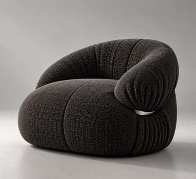 A contemporary, generously padded armchair with a sculptural and organic form, upholstered in a dark charcoal grey fabric with subtle white flecks. The chair features a rounded, low-slung profile and distinct pleating or gathering of the fabric, particularly evident around the armrests and base, giving it a plush, cloud-like appearance. A single, sleek silver-toned metal ring acts as a decorative and structural detail on one side, cinching the upholstery. — 3D model