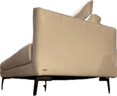 A modern sofa upholstered in white or off-white leather, featuring a minimalist design with a low profile. It has integrated, wide armrests and a deep seat. The backrest is formed by multiple loose cushions, which are secured by visible black straps. The upholstery exhibits subtle texture and detailed stitching along the edges, suggesting a contemporary and sophisticated aesthetic. — 3D model