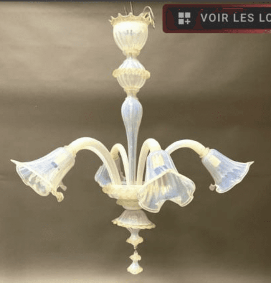 A decorative chandelier with multiple arms, each ending in a bell-shaped glass shade. The central body features stacked elements, with rope-like detailing on one section. The overall design suggests an ornate style. — 3D model