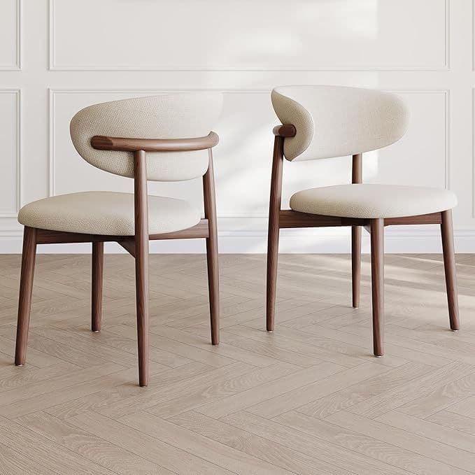 A modern dining chair with a curved backrest and a padded seat. The frame and legs are made of dark wood, with a distinct grain visible. The upholstery is a light, textured fabric. The backrest features a unique wooden accent connecting it to the frame. — 3D model